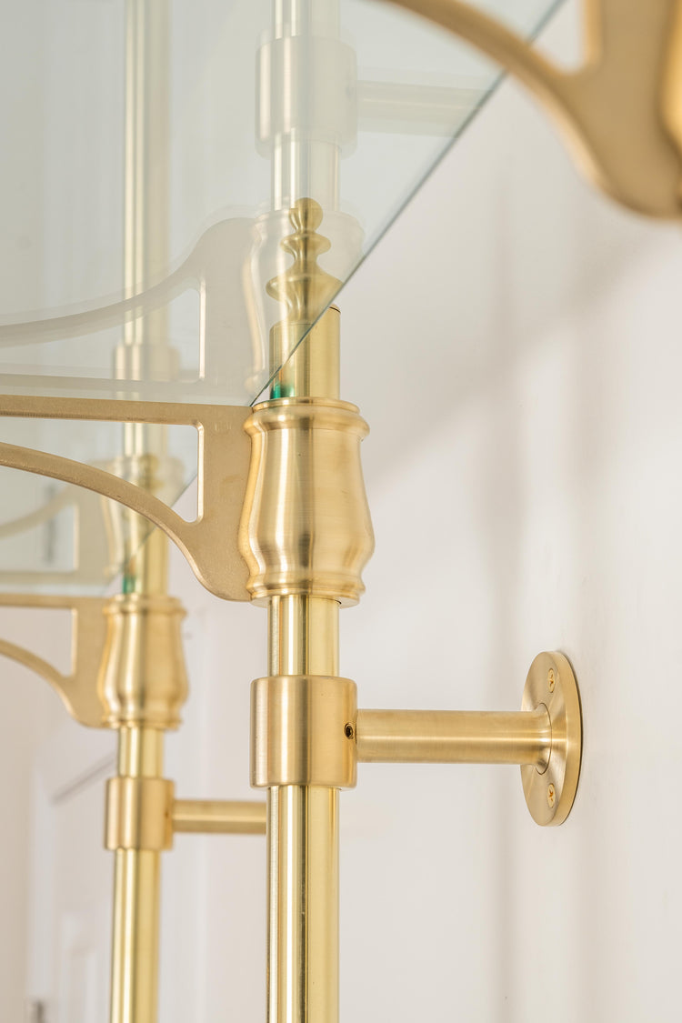 A wall mounting post made from real brass used to hold a bistro shelving unit to the wall.
